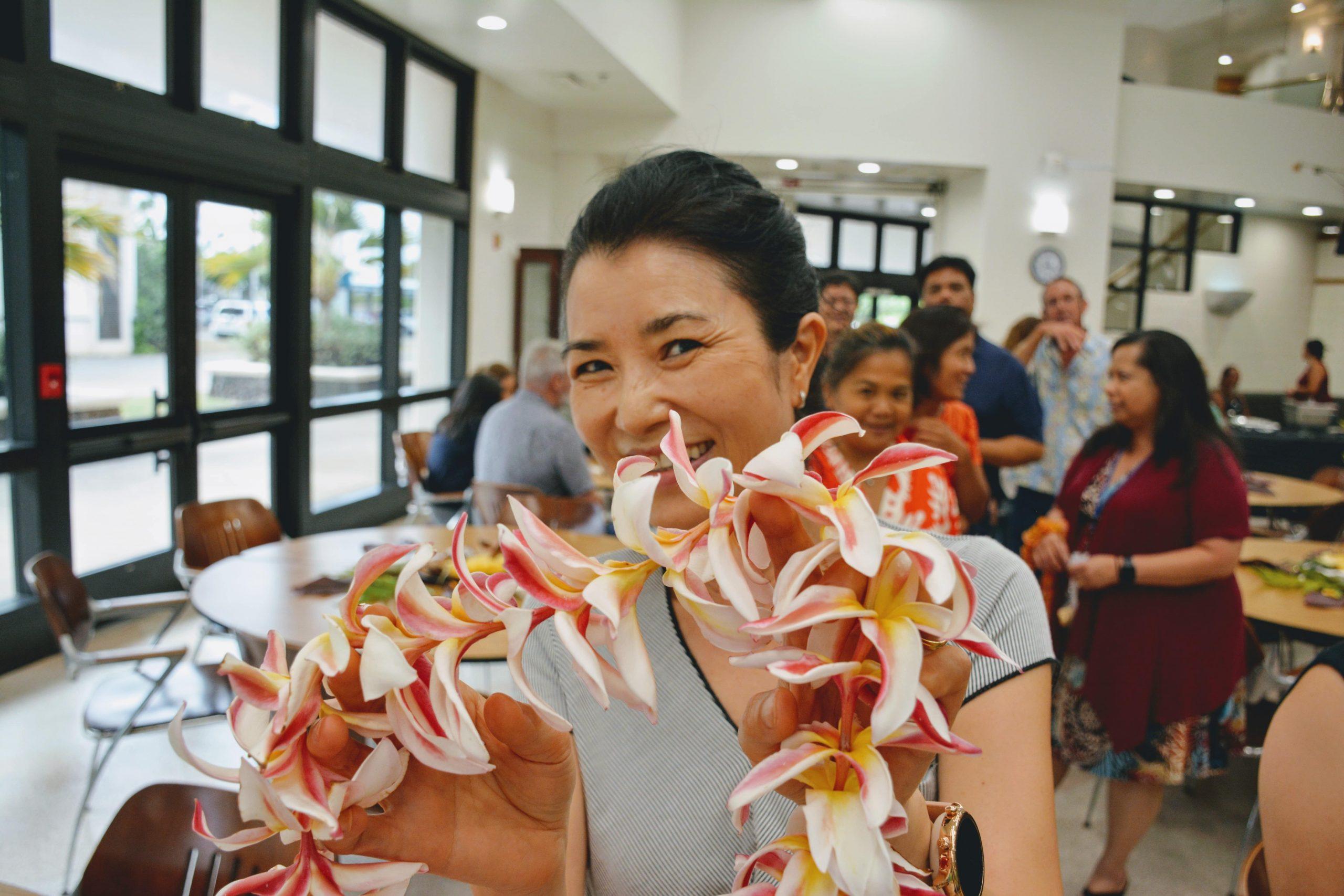 Student giving a lei